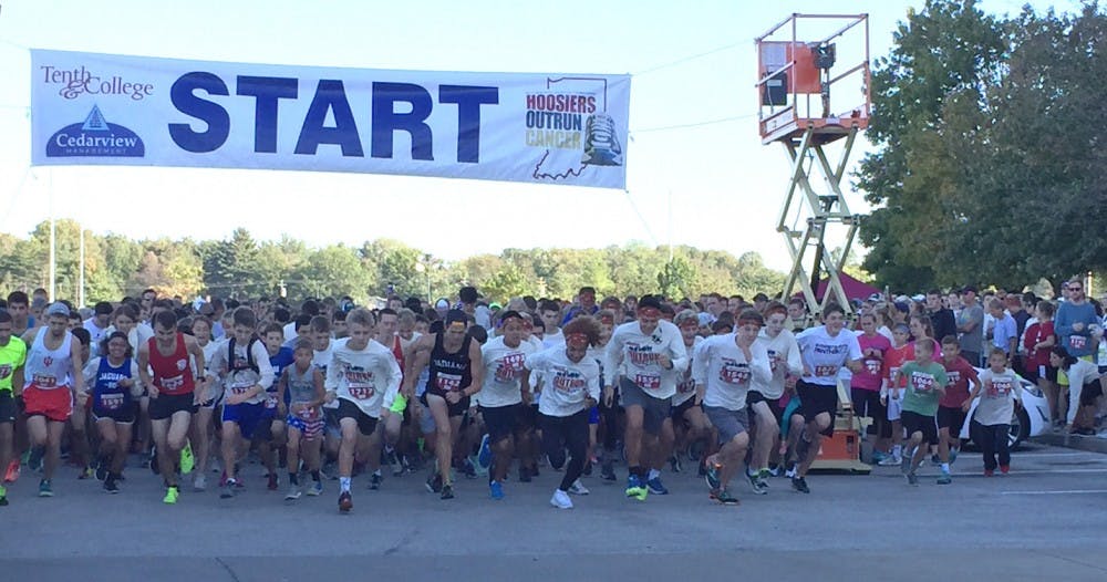 <p>Runners take off at the start of Hoosiers Outrun Cancer fundraising race.</p>