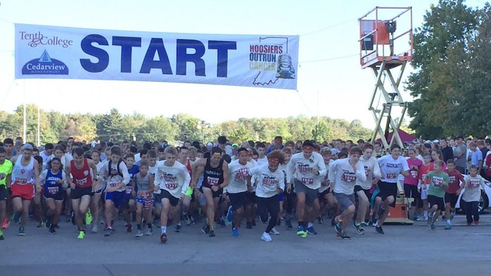 Runners take off at the start of Hoosiers Outrun Cancer fundraising race.