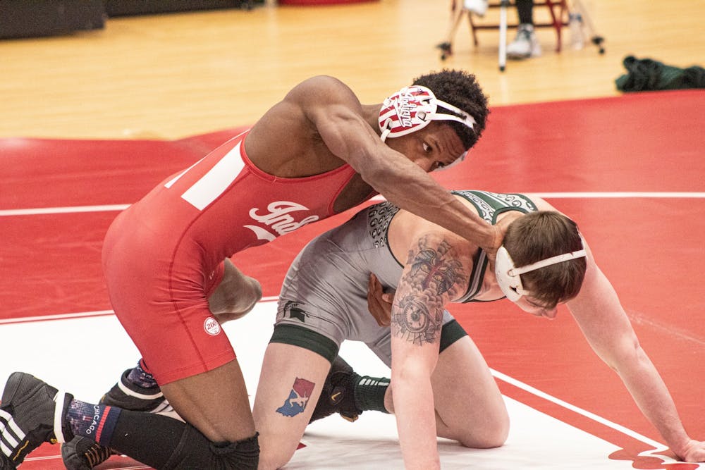 <p>IU sophomore DJ Washington and Michigan State senior Drew Hughes face off during their match on Feb. 6, 2021, at Wilkinson Hall in Bloomington. Indiana won both of its tri-dual matches 40-3.</p>