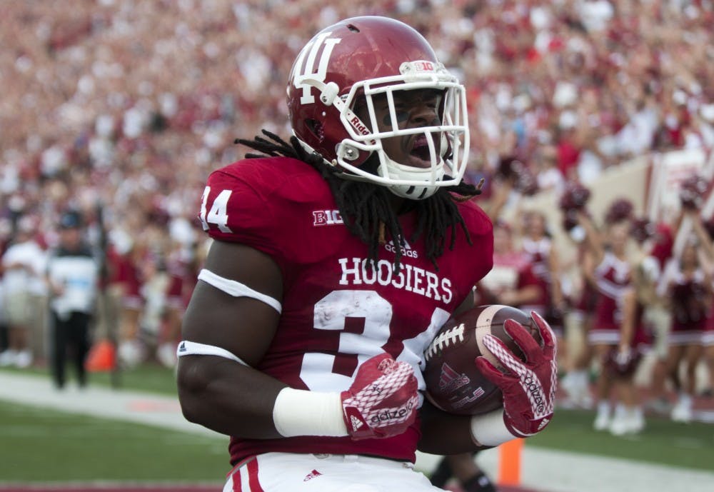Running back Devine Redding celebrates after scoring the first touch down of the game against Southern Illinois on Saturday at Memorial Stadium. The Hoosiers won 48-47.