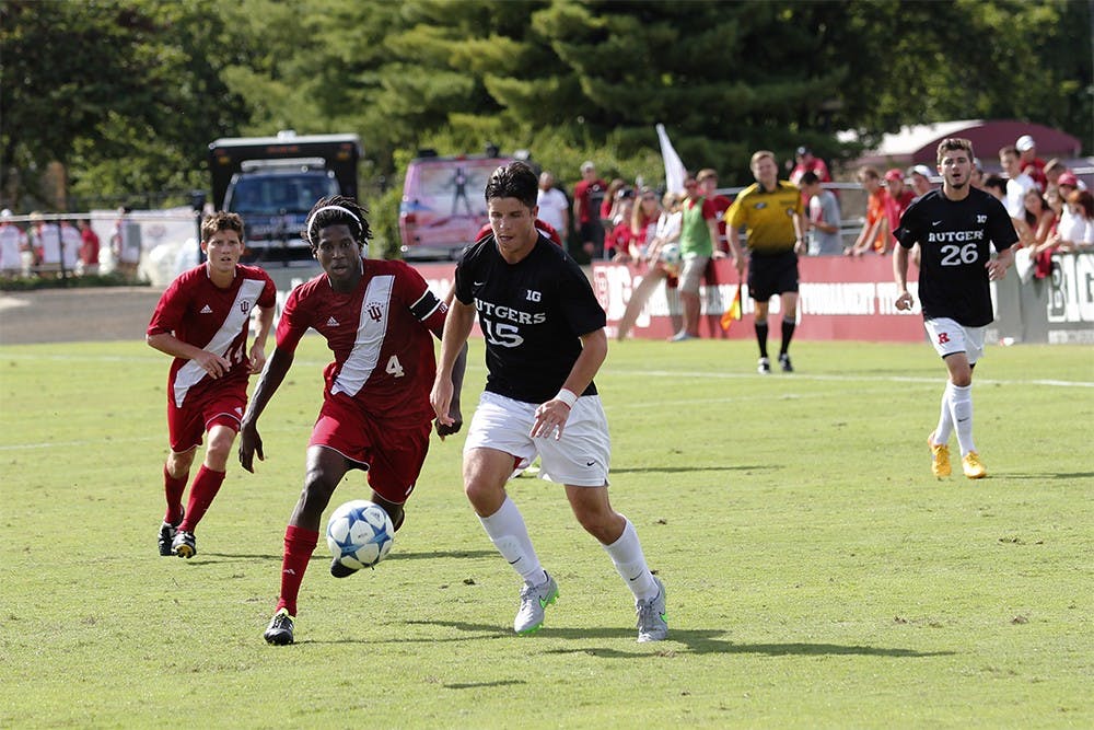 Senior forward Femi Hollinger-Janzen fights for the ball during IU's game against Rutgers Sunday at the Armstrong Stadium.