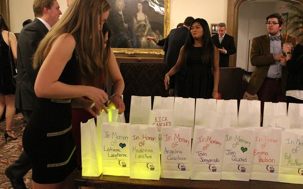 Abby Quaid, on the gala planning committee,  prepares the luminaria for the ceremony after dinner. Because the ceremony is taking place indoors the committee opted for glowsticks as opposed to candles in the luminaria. 