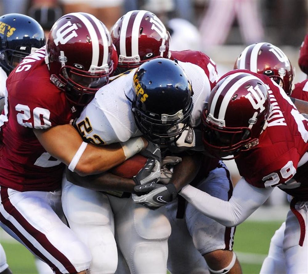 A group of IU defenders tackle Murray State running back Charlie Jordan during their 45-3 victory Saturday night at Memorial Stadium.  The Hoosier defense held the Racers to 149 total yards.