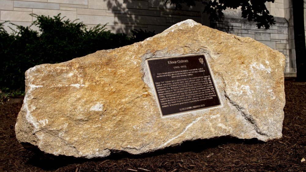 A marked rock with a plaque sits on fresh mulch Oct. 7 in front of Woodburn Hall. The rock was dedicated to IU alumna Nobel prize winner Elinor Ostrom.