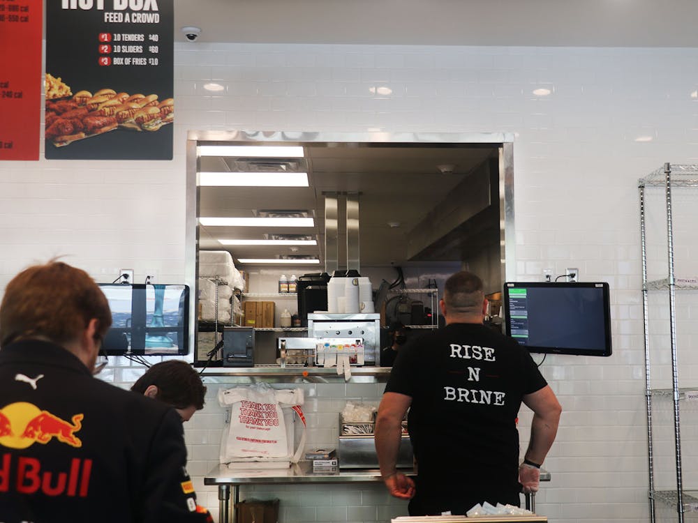 The staff of Dave&#x27;s Hot Chicken prepare food orders for its lunch time rush. The menu includes a variety of options for its customers including sliders, sandwiches or chicken served on its own. 