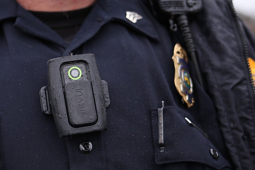 Bloomington Police Sgt. Connolly wears his body camera at the scene of a fire at the Village Deli on Sunday afternoon. 