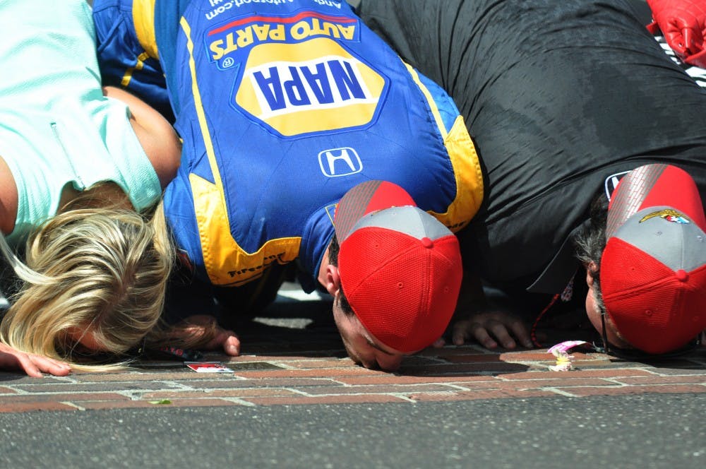 IndyCar rookie Alexander Rossi kisses the brick yard at Indianapolis Motor Speedway. Rossi stretched his car's fuel to win the 100th running of the Indy 500 on May 29,&nbsp;2016.