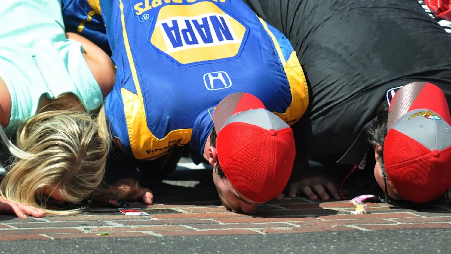 IndyCar rookie Alexander Rossi kisses the brick yard at Indianapolis Motor Speedway. Rossi stretched his car's fuel to win the 100th running of the Indy 500 on May 29, 2016.