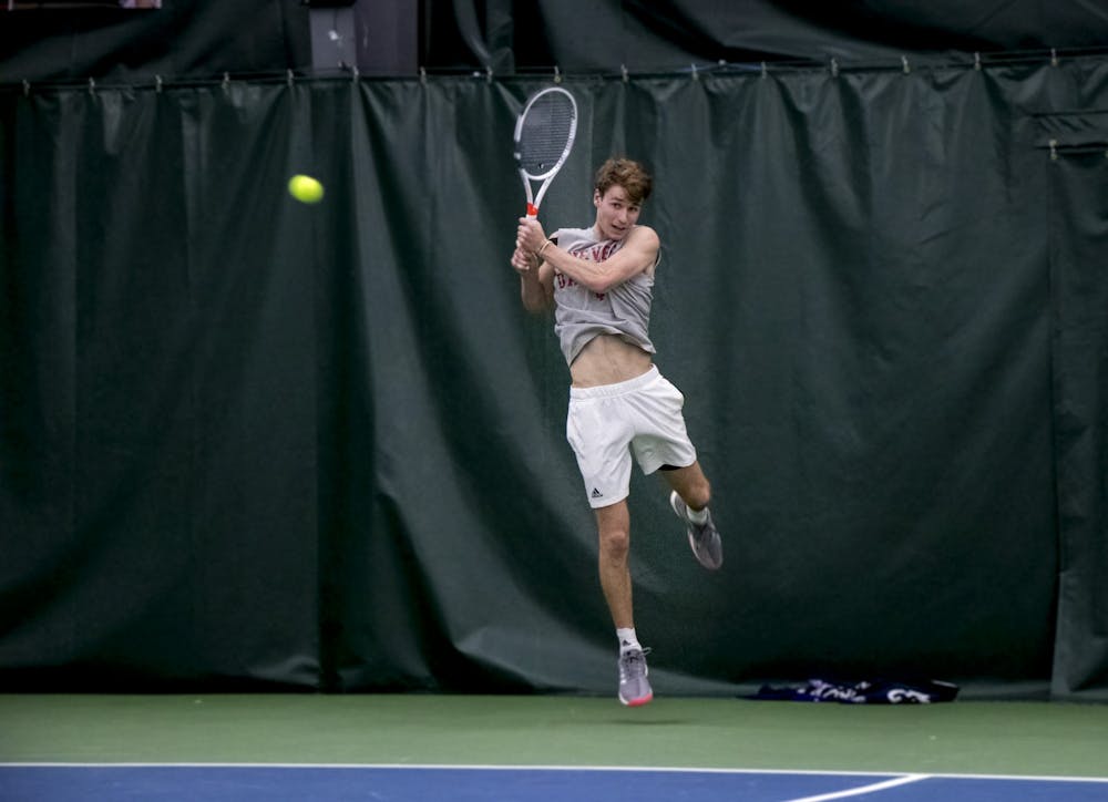 <p>IU senior Bennett Crane leaps for the ball in a match against the University of Memphis on Jan. 17 at the IU Tennis Center. Crane is the highest ranked Hoosier since Sam Monette in 2016, who opened the season at No. 27.</p>