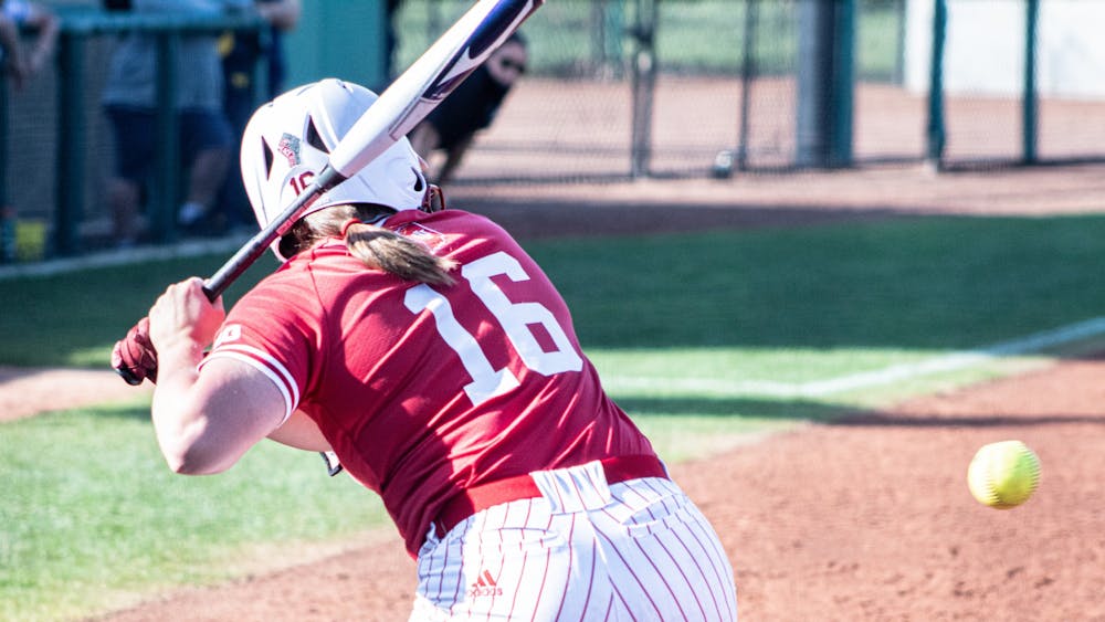 Graduate student infielder Micah Schroder watches as the pitch comes in Saturday at Andy Mohr Field. The IU softball team was swept in its four-game series against Michigan this weekend. 