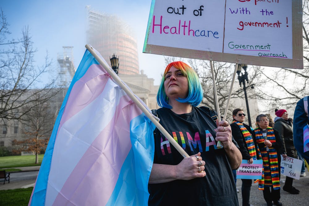 <p>Sarah Newton stands with a trans pride flag during a rally to protest the passing of Senate Bill 150 on March 29, 2023 at the Kentucky State Capitol in Frankfort, Kentucky. The American Civil Liberties Union of Indiana filed a lawsuit Monday challenging an Indiana law banning gender-affirming sexual reassignment surgeries for anyone imprisoned in Indiana after the state’s correctional agency denied a procedure for an incarcerated transgender woman.  <br/></p>