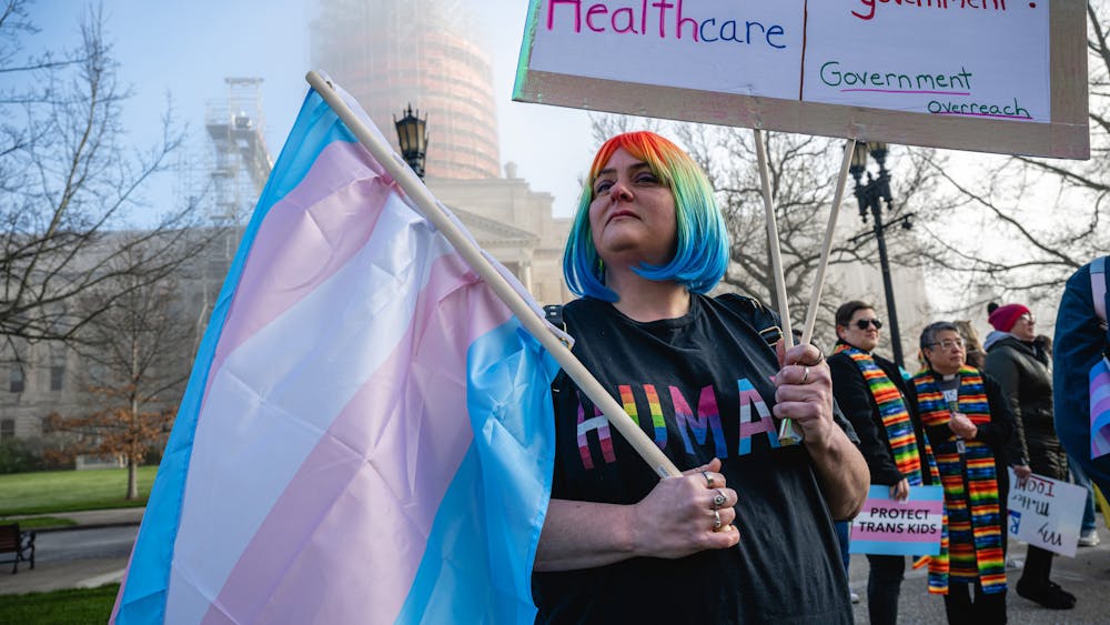 Sarah Newton stands with a trans pride flag during a rally to protest the passing of Senate Bill 150 on March 29, 2023 at the Kentucky State Capitol in Frankfort, Kentucky. The American Civil Liberties Union of Indiana filed a lawsuit Monday challenging an Indiana law banning gender-affirming sexual reassignment surgeries for anyone imprisoned in Indiana after the state’s correctional agency denied a procedure for an incarcerated transgender woman.  