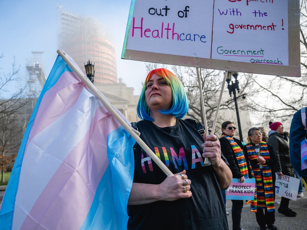 Sarah Newton stands with a trans pride flag during a rally to protest the passing of Senate Bill 150 on March 29, 2023 at the Kentucky State Capitol in Frankfort, Kentucky. The American Civil Liberties Union of Indiana filed a lawsuit Monday challenging an Indiana law banning gender-affirming sexual reassignment surgeries for anyone imprisoned in Indiana after the state’s correctional agency denied a procedure for an incarcerated transgender woman.  