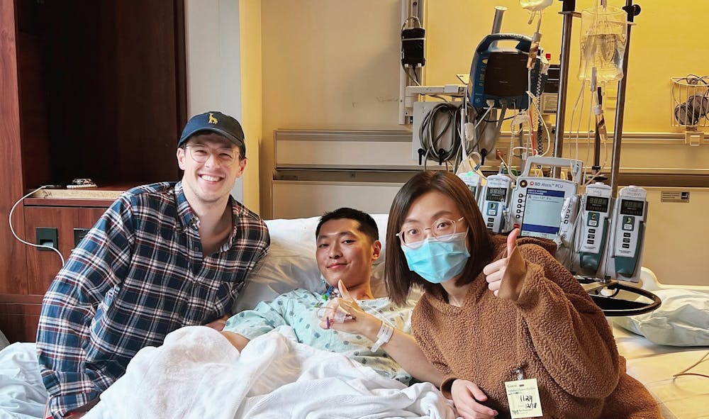 <p>Christian Daake (left), Yi Jia and Shiqiao Wang pose for a photo on Dec, 18, 2021, at Northwestern Medical Hospital. Jia received a liver donation from Daake a few days prior to treat his stage-four cancer.</p>