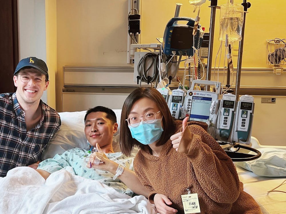 Christian Daake (left), Yi Jia and Shiqiao Wang pose for a photo on Dec, 18, 2021, at Northwestern Medical Hospital. Jia received a liver donation from Daake a few days prior to treat his stage-four cancer.