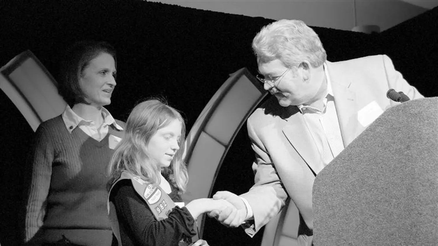 Tutto Bene owner Craig Widen, right, presents the Volunteer Award to Kate Perry, center, and her family during Downtown Bloomington Incorporated’s annual meeting and award ceremony Thursday afternoon at the convention center. The Perry family won for its support of the annual Downtown Easter Egg Hunt.