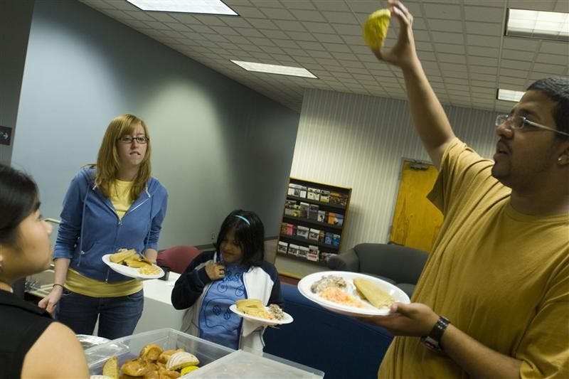 Foster RA Jorge Wellmann displays pan dulce to attendees of a Day of the Dead celebration Sunday evening in the Foster Harper Formal Lounge. The event also included an explanation of the holiday by Jorge and Foster Residence Coordinator Zelideh Cabada, a few related activities, and free food.