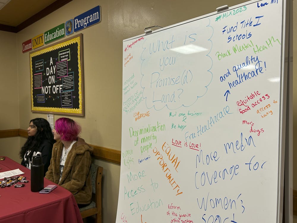 A whiteboard stands filled with the requests of students to their promised land on Jan. 16, 2023, at Forest Dining Hall. CommUNITY Educators with whiteboards were stationed at Wright, Forest and McNutt, handing out brochures about Martin Luther King Jr. and other influential Black leaders in history. 