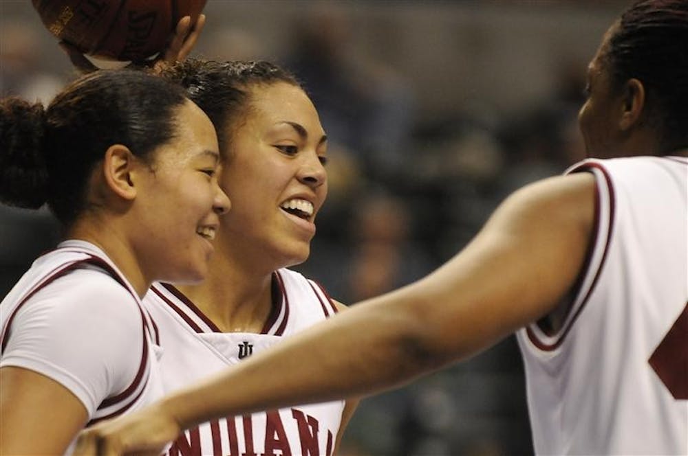 IU seniors Kim Roberson, left, Whitney Thomas and Amber Jackson share a laugh during the closing minutes of IU's 68-50 win against Michigan in the first round of the Big Ten Tournament on Thursday at Conseco Fieldhouse in Indianapolis.