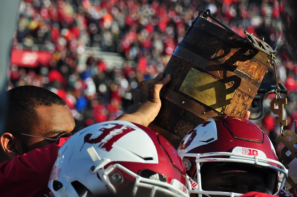 <p>IU holds up the Old Oaken Bucket trophy after their 26-24 win over Purdue on Nov. 26, 2016 at Memorial Stadium.</p>