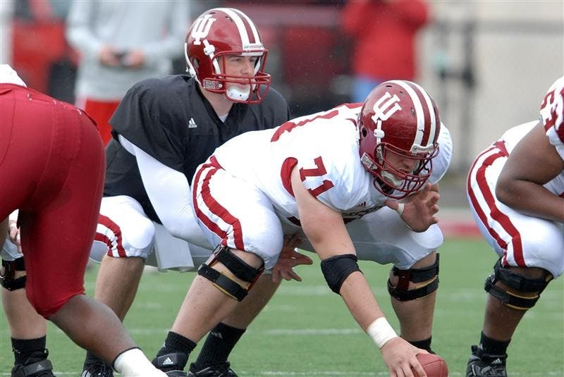 Sophomore Alex Perry prepares to snap the ball to quarterback sophomore Ben Chappell during preseason practice. Perry will be the  center in this year’s new no-huddle offense.