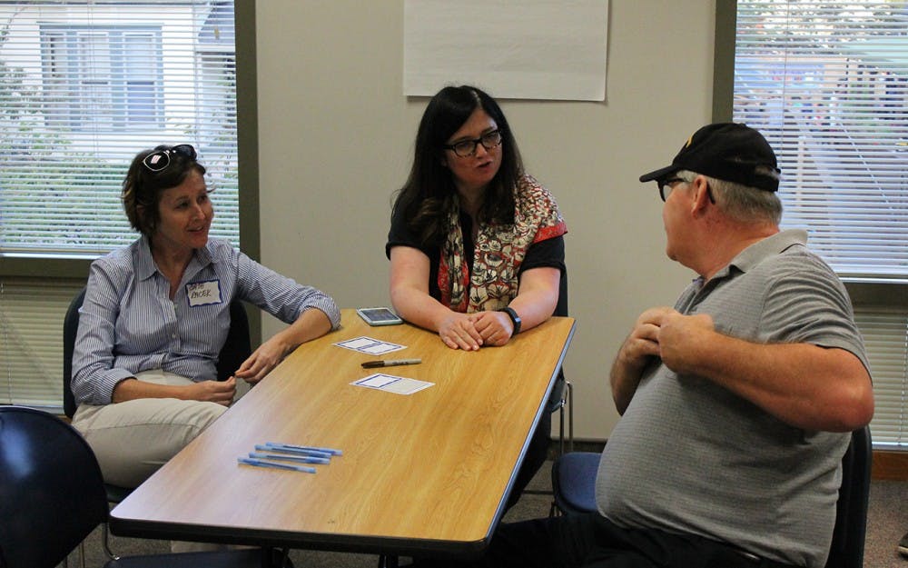 Media School Professor of Practice, Elaine Monaghan talks with residence at the refugee support network meeting on Thursday evening.