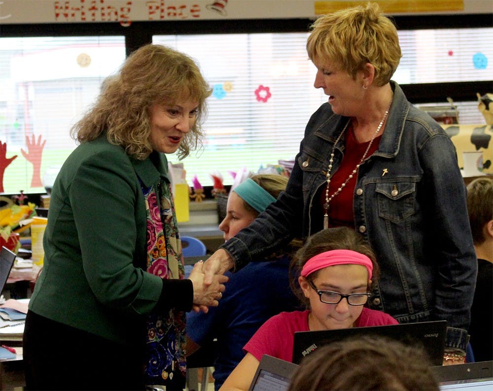 State Superintendent of Public Instruction Glenda Ritz greets a teacher inside a Brown County Junior High School classroom April 11. Ritz often travels around the state to visit schools and meet educators and students. 