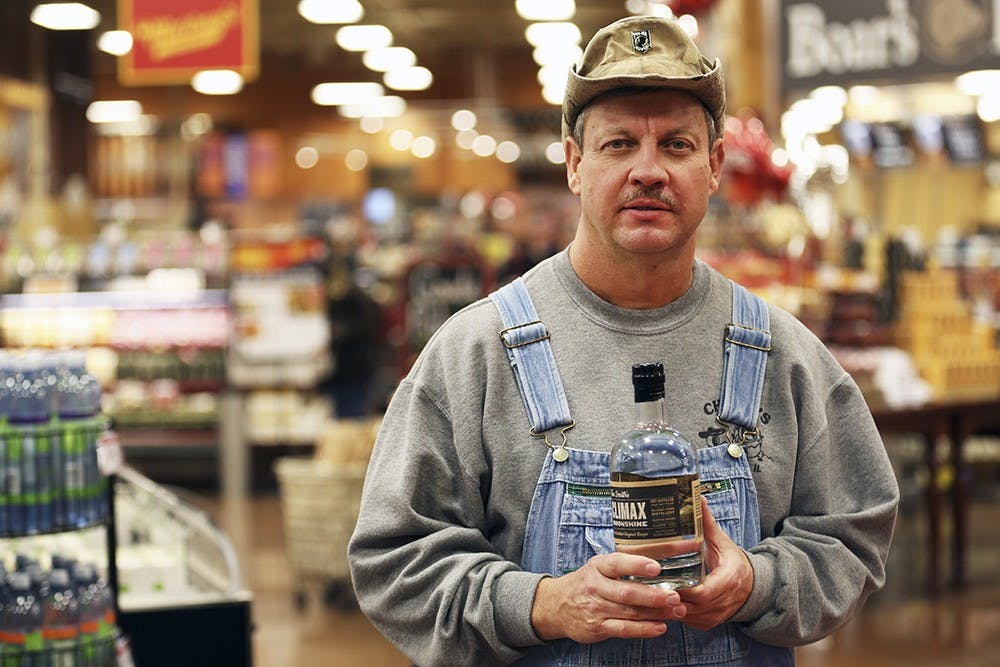 Tim Smith of Discovery Channel's "Moonshiners" promotes his Climax Moonshine at the east side Kroger during the store's Grand Reopening. 