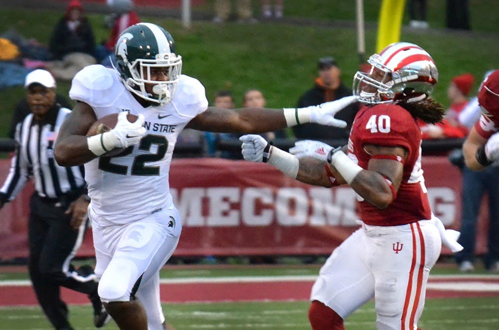 Michigan State running back Delton Williams stiff arms IU sophomore safety Antonio Allen in the Hoosiers' homecoming game against Michigan State on Oct. 18 at Memorial Stadium.