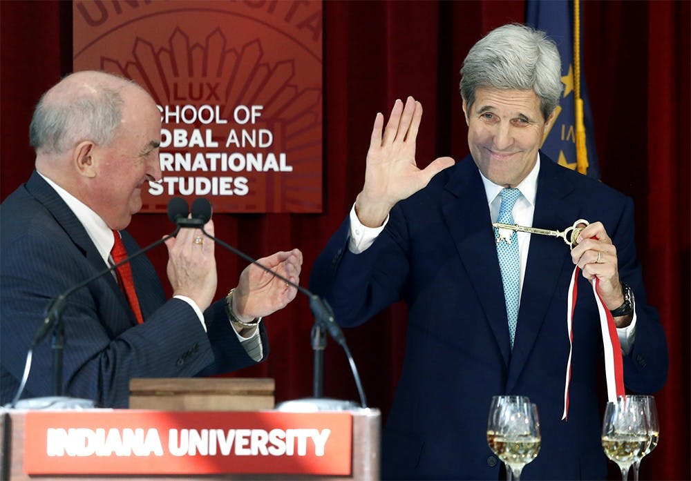 Secretary of State John Kerry shows the Global and International Studies Building key, given by the President of IU Michael A. McRobbie, left, to audiences inside of the same building on Thursday, Oct. 15. 