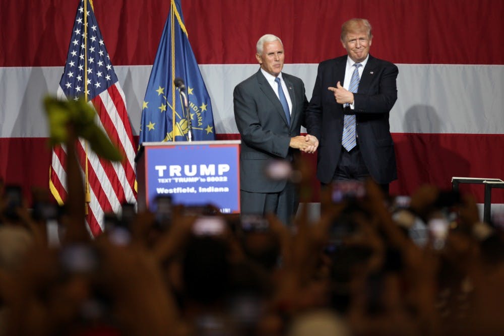 Governor Mike Pence and Republican Presidential Candidate Donald Trump address the crowd after Pence introuces Trump to the stage during a Trump rally in Westfield, Ind. on Tuesday evening.