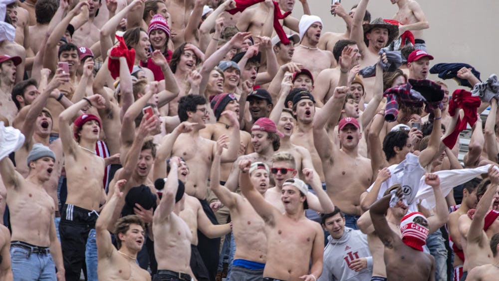 Shirtless students cheer at the Indiana football game against Rutgers on Nov. 13, 2021, at Memorial Stadium. Students began congregating in section 19, took their shirts off and cheered before halftime of the 38-3 loss.