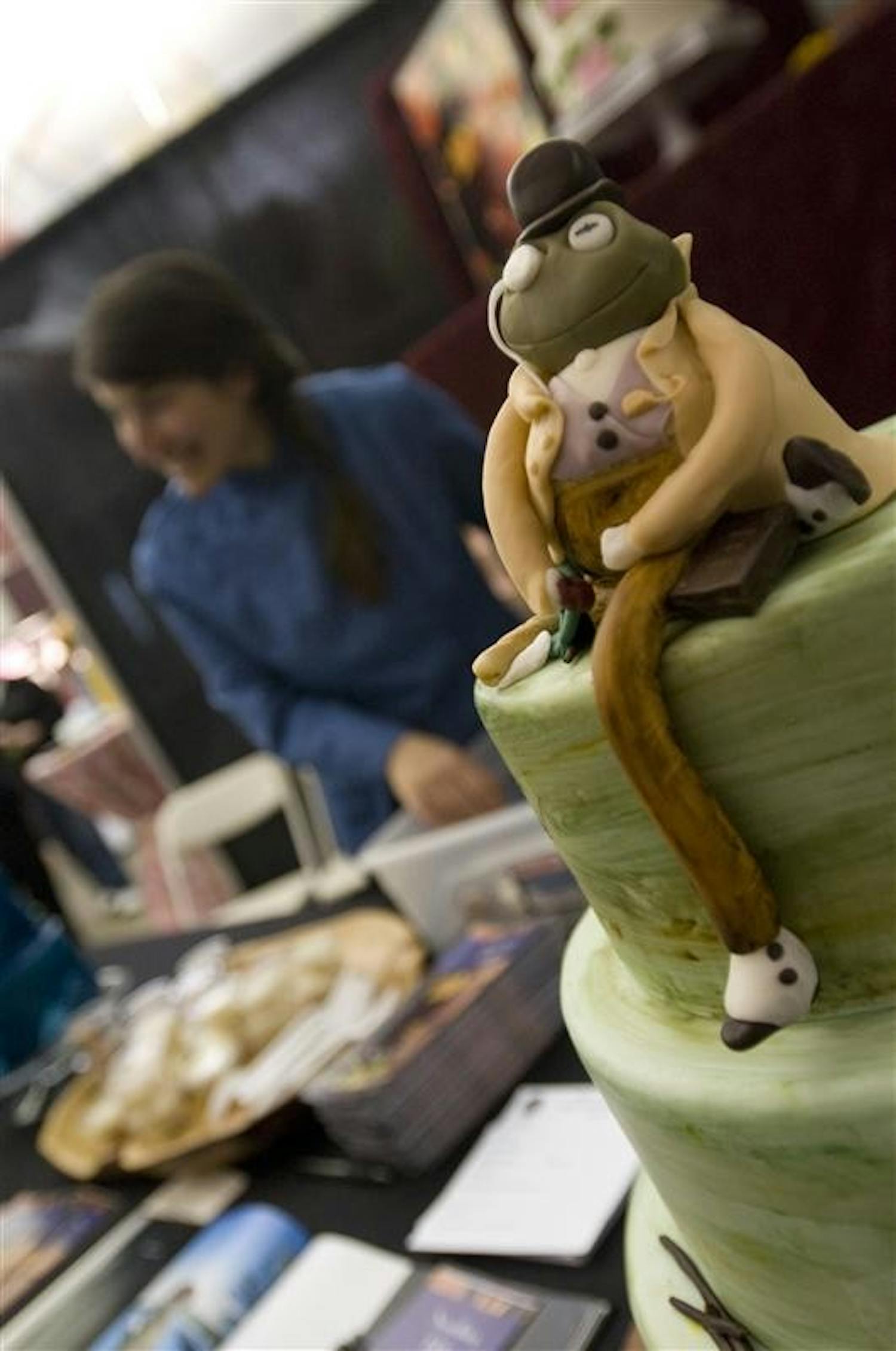 A frog sits atop a cake by Stacy Strand of Blu Boy Chocolate Cafe and Eatery Sunday afternoon at the Bloomington Bridal Show in the Bloomington Convention Center.