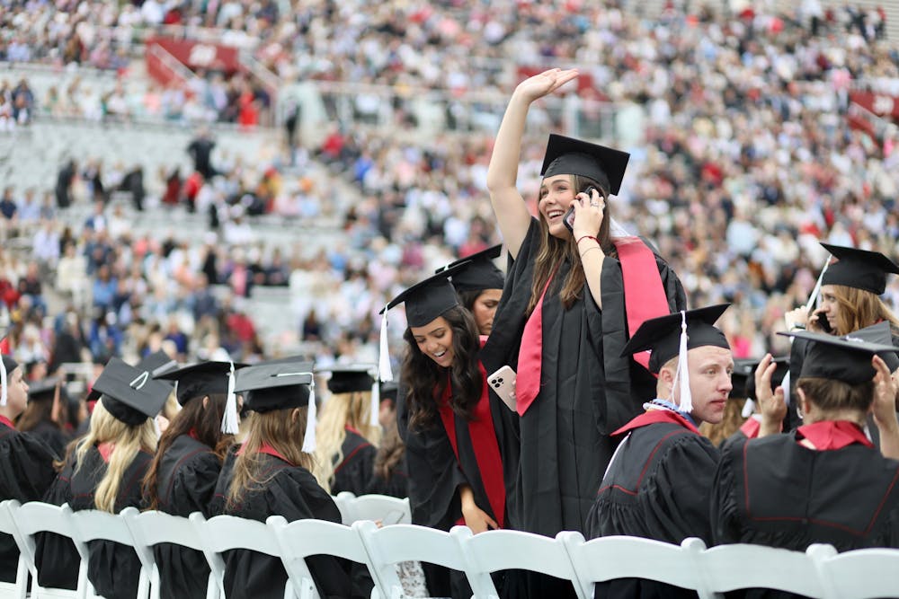 <p>A student waves to friends and family before the 194th undergraduate commencement. IU honored more than 20,000 graduates in total across the state.﻿</p>