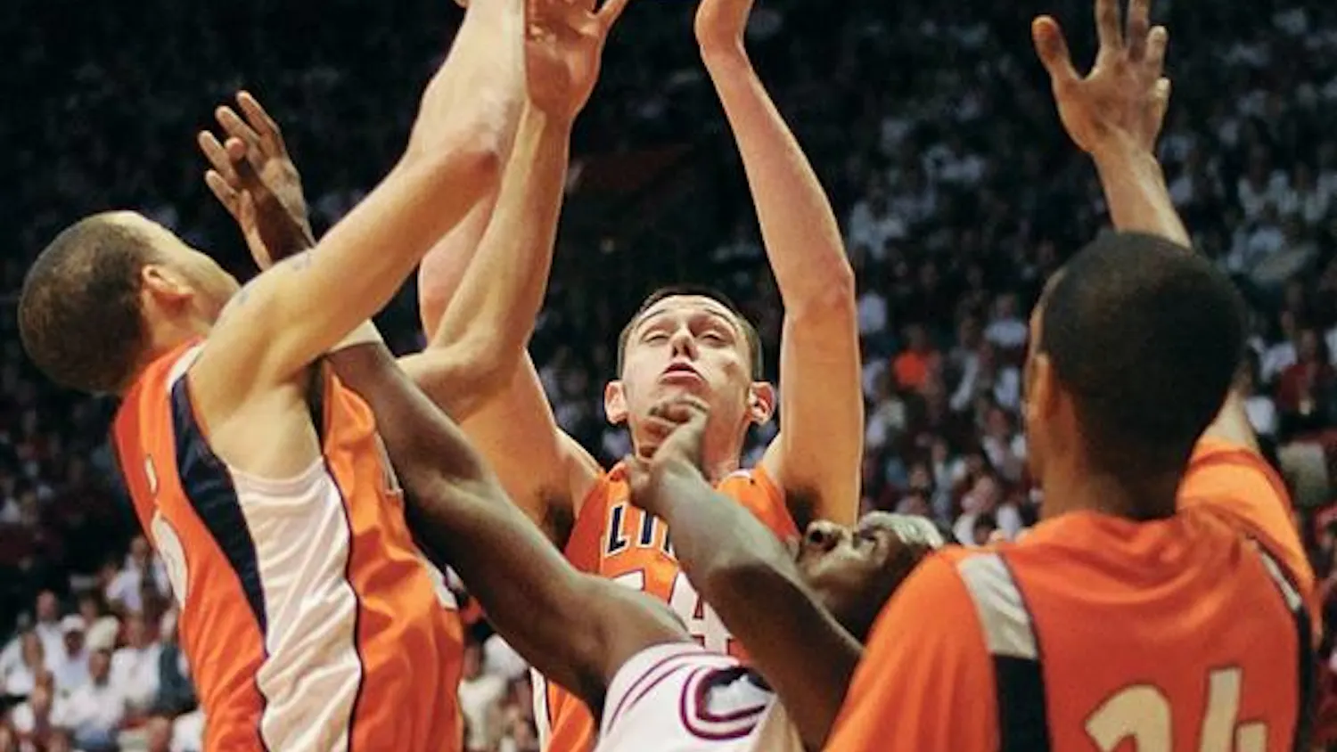 IU freshman guard Nick Williams battles for an offensive rebound with three Ilinois defenders during the first half of IU's 65-52 loss Sunday at Assembly Hall. Ilinois had 37 rebounds.