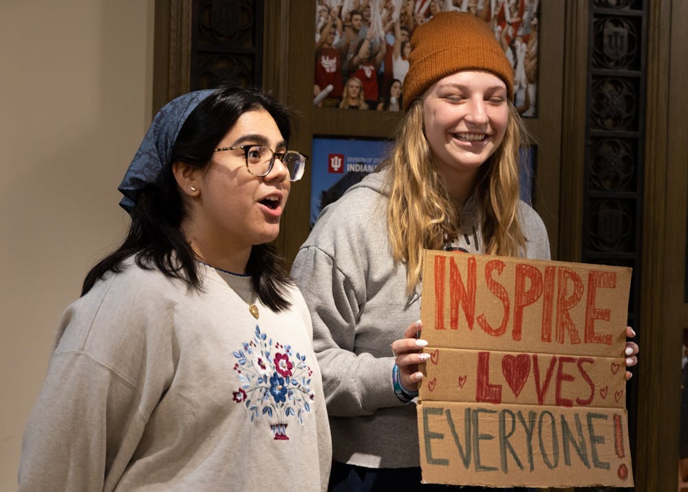 <p>Students Ava Roblero and Quinn Sever show off their sign Feb. 2, 2023, outside the Whittenberger Auditorium. The students were representatives of the Inspire LLC and came to the event to support the community as future educators.</p>