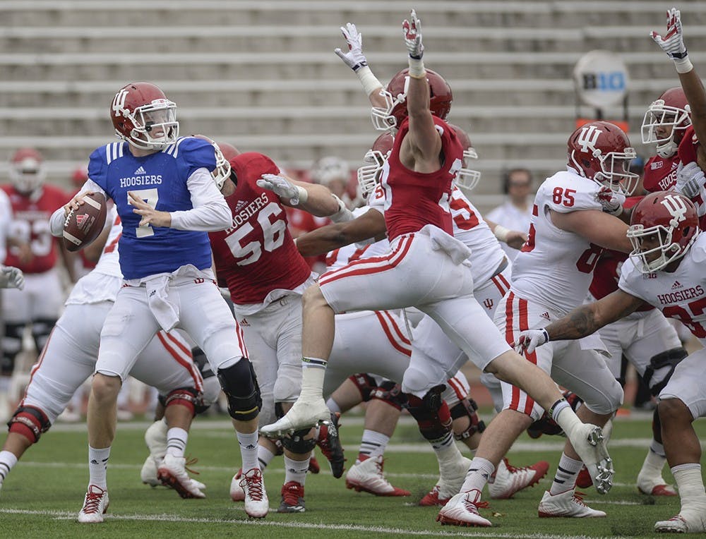 Senior quarterback Nate Sudfeld is rushed while he tries to throw during IU's spring game Saturday at Memorial Stadium.