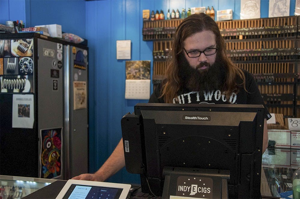 Justin Meier, the manager of the Indy E-cigs, works in his shop on Wednesday at the Indy E-cigs. Indy E-cigs is a vapor shop. 