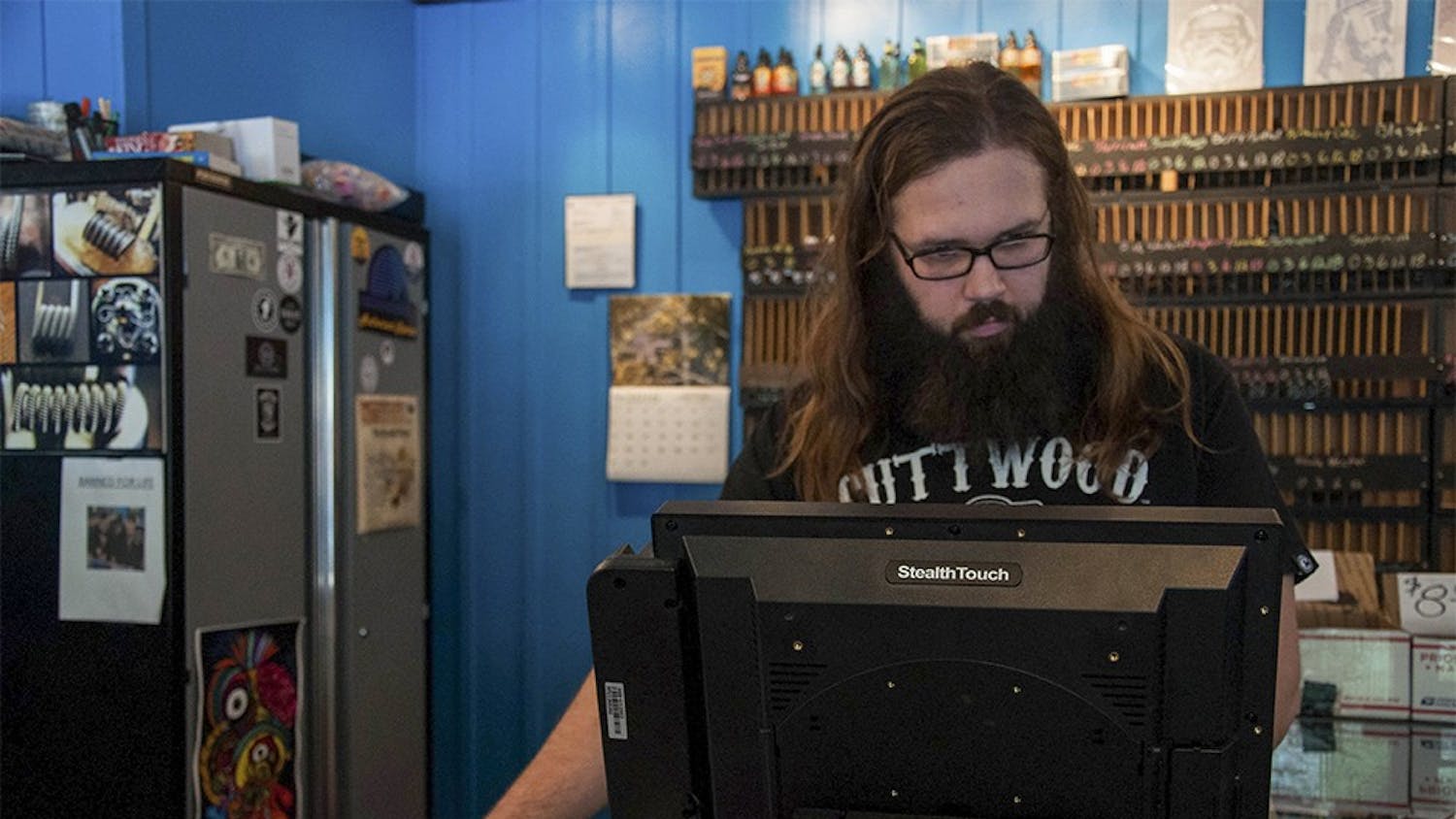 Justin Meier, the manager of the Indy E-cigs, works in his shop on Wednesday at the Indy E-cigs. Indy E-cigs is a vapor shop. 