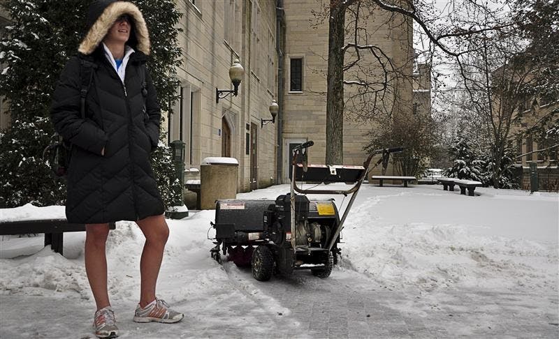 Sophomore Megan Uhab waits Tuesday afternoon outside the Indiana Memorial Union as Bloomington remains under a Winter Storm Warning. Uhab had just finished working out and was waiting patiently for a ride.