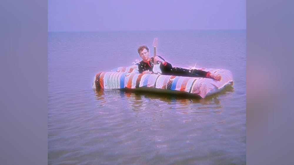 Michael Bruner lays on a mattress in Lake Michigan for his "all the pressure" music video. The song was released July 27. 
