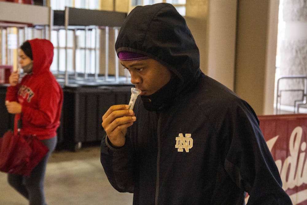 <p>Indiana University sophomore K.J. Helloms submits a saliva sample for COVID-19 mitigation testing Oct. 15, 2020, at Memorial Stadium. IU Chief Health Officer Aaron Carroll said contact tracing is facing an increased volume of COVID-19 cases this semester. </p>