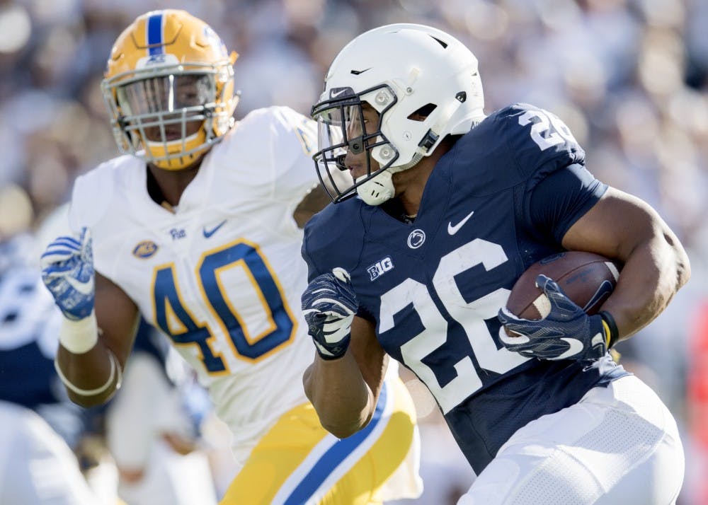 Penn State junior running back Saquon Barkley looks to pick up yardage against Pitt's James Folston Jr. on Sept. 9 at Beaver Stadium in University Park, Pennsylvania. IU running backs coach Mike Hart said that Barkley is the best running back in the country.&nbsp;