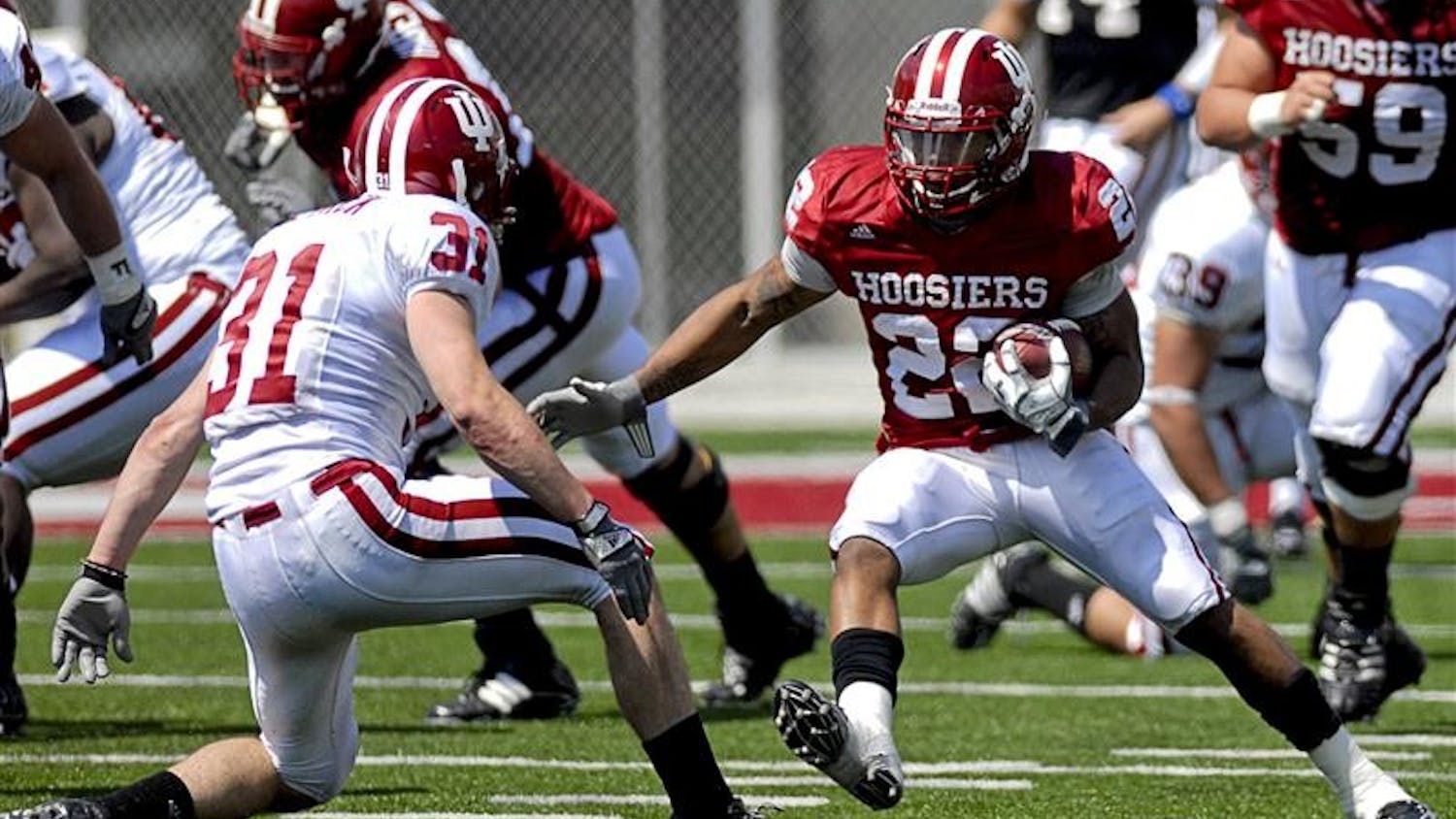 Running back Darius Willis tries to evade safety Kyle Detrick during the Spring Game on Saturday afternoon at Memorial Stadium. The Crimson team won 28-27.