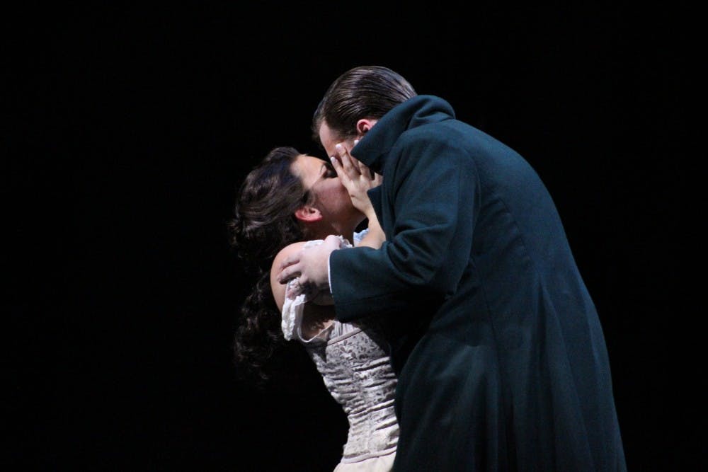 <p>Rose-Antoinette Bellino, a first-year master's degree candidate, and Joseph McBrayer, a first-year graduate student, kiss as their characters, Lucia Ashton and Edgardo Ravenswood, bid one other farewell. "The opera is a story of true love's conflict, duties to the family, and what can happen to a mind under pressure," director Jose Maria Condemi said. "I felt it fit well in the Victorian era, with the ghosts, the constraints on women, while at the same time allowing me more freedom to create."</p>