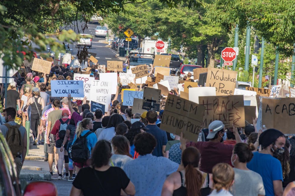 <p>Protesters march July 7 up Kirkwood Avenue toward the Sample Gates. Instead of turning onto Dunn Street like the evening before, the group marched all the way to Indiana Avenue before turning right and right again onto Third Street.</p>