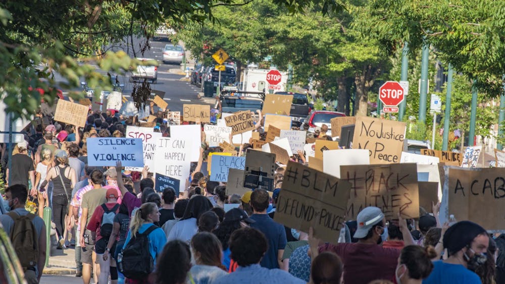 Protesters march July 7 up Kirkwood Avenue toward the Sample Gates. Instead of turning onto Dunn Street like the evening before, the group marched all the way to Indiana Avenue before turning right and right again onto Third Street.