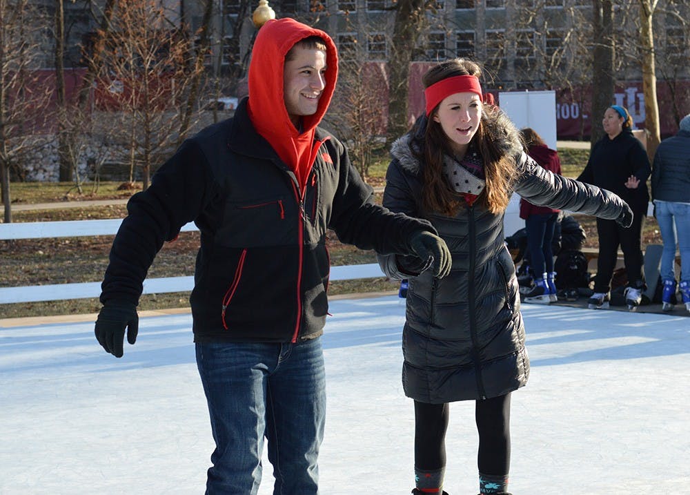 Junior Levi Snow and senior Megan McKee hold each other up on the ice rink in Dunn Meadow on Tuesday. The ice rink is part of Winter Welcome Week hosted by Union Board.