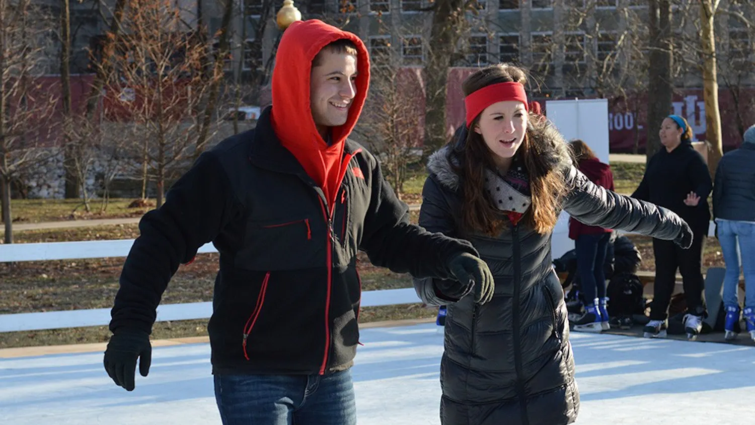 Junior Levi Snow and senior Megan McKee hold each other up on the ice rink in Dunn Meadow on Tuesday. The ice rink is part of Winter Welcome Week hosted by Union Board.