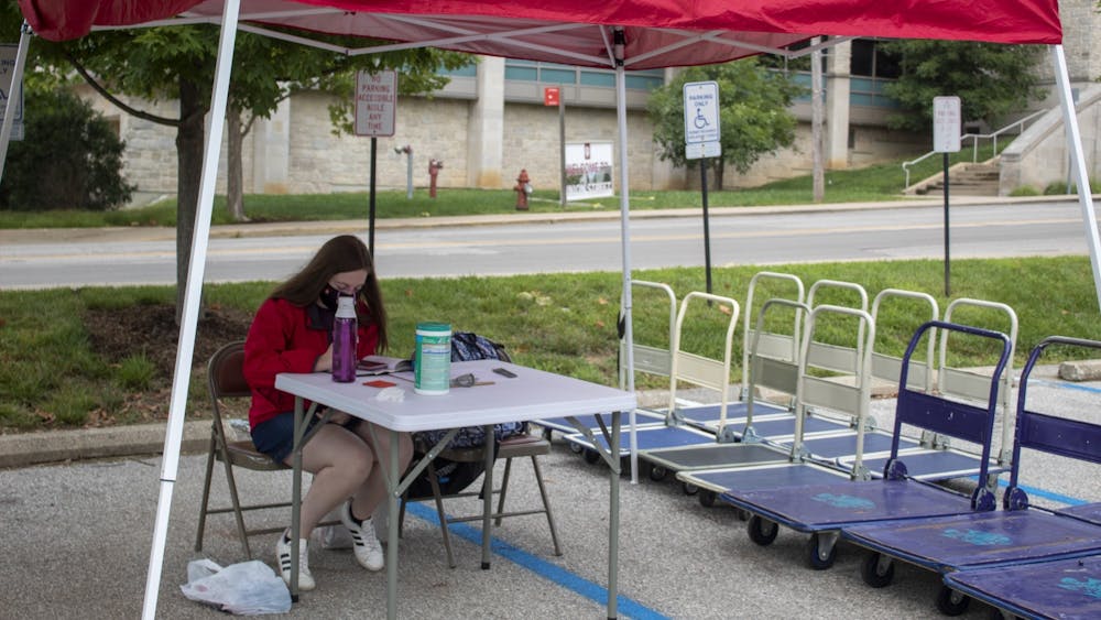 Residential assistant Jada Collins runs the cart sign-out station Aug. 18 outside of Eigenmann Hall. IU Student Association passed a bill paying residential assistants&#x27; and CommUNITY educators&#x27; hazard pay.